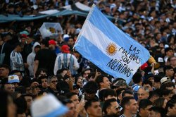 Argentina fans display 'Falkland's belong to us' banner at Messi's final game